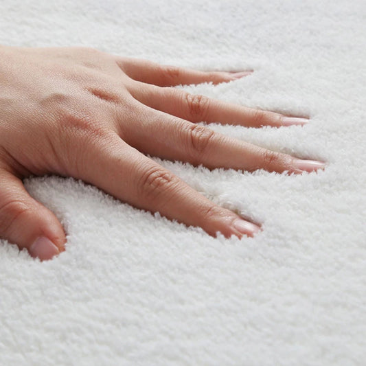 Hand touching a textured white surface