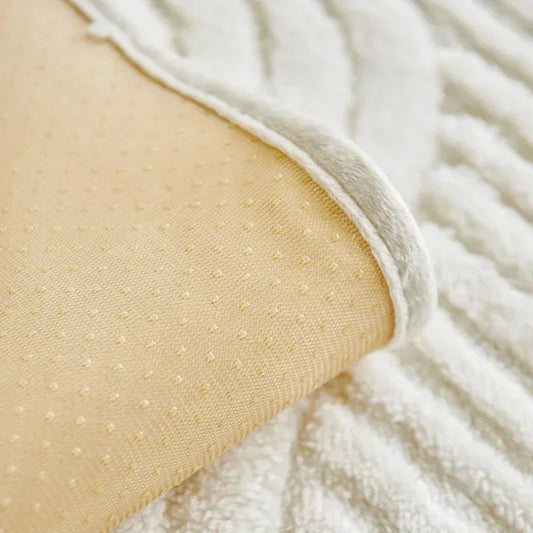 Close-up of beige textured fabric with white fluffy material in the background