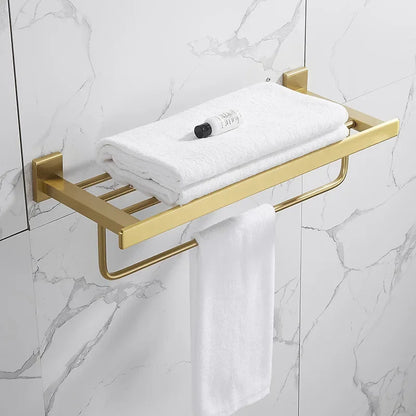 Gold towel rack with white towels on a marble bathroom wall