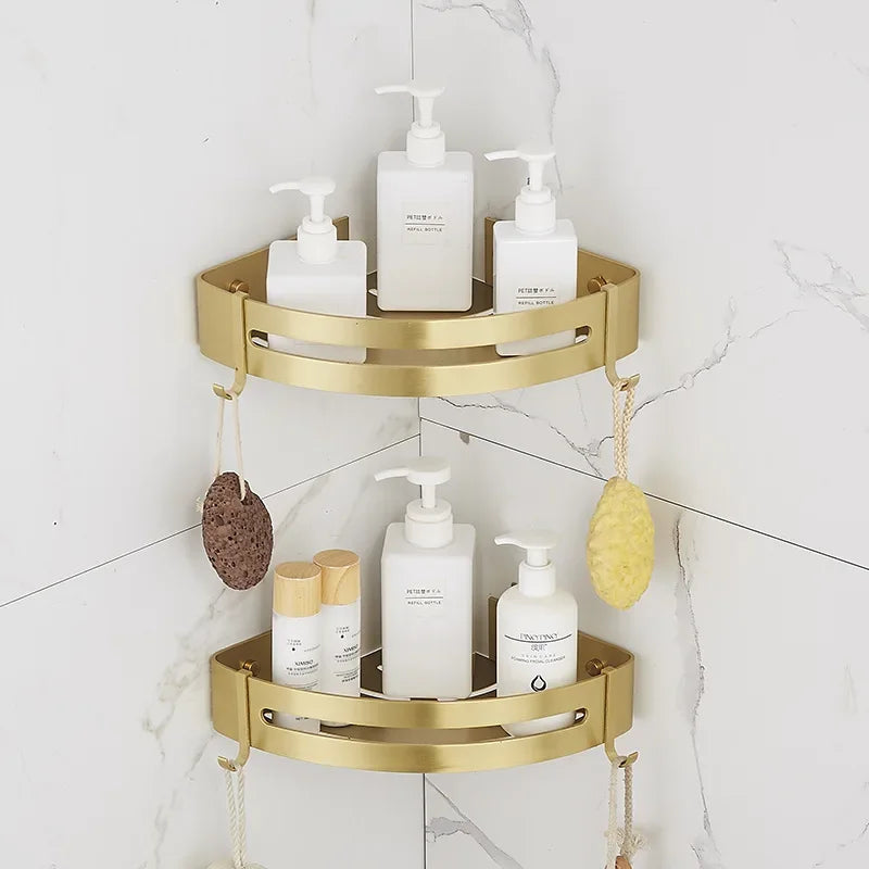 Gold corner shelf with bathroom products against a white tiled wall