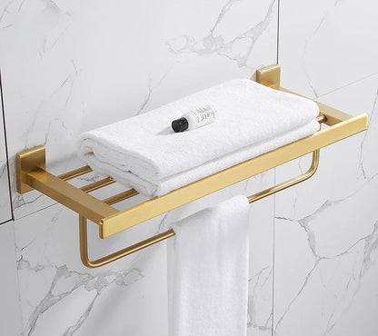 Gold towel rack with white towels on a marble wall