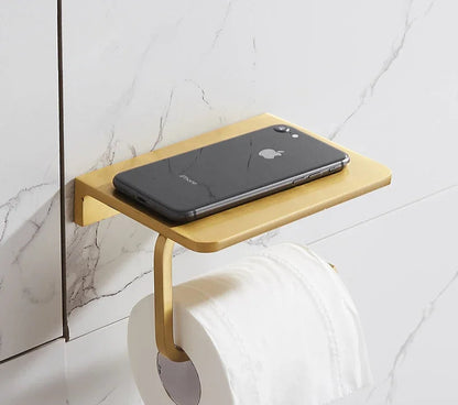 Wooden shelf attached to a toilet with a smartphone on top, against a marble wall.