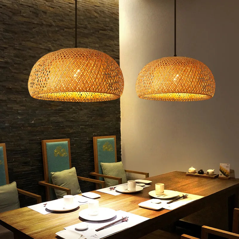 Dining area with wicker pendant lights, wooden table, and chairs.