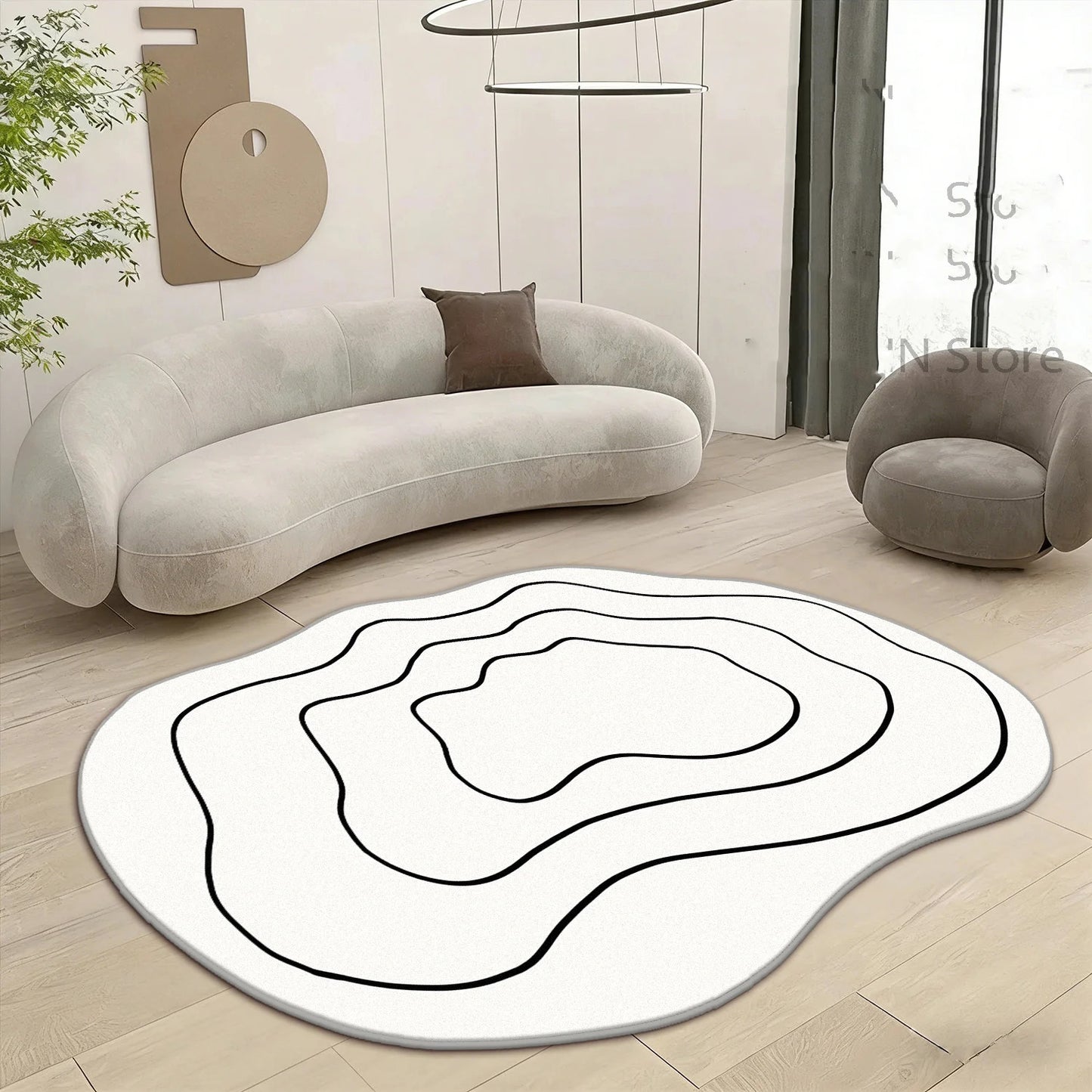 Round black and white rug on a wooden floor with a modern sofa and chair in the background.