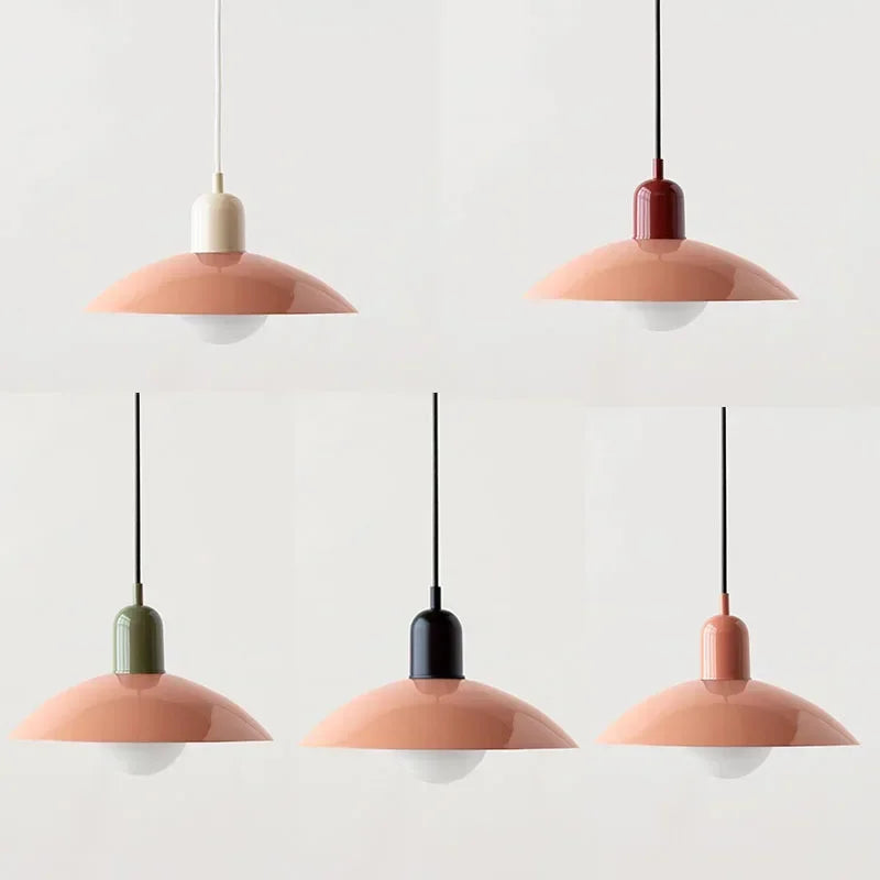 Set of five pendant lights with pink and gold bases on a white background