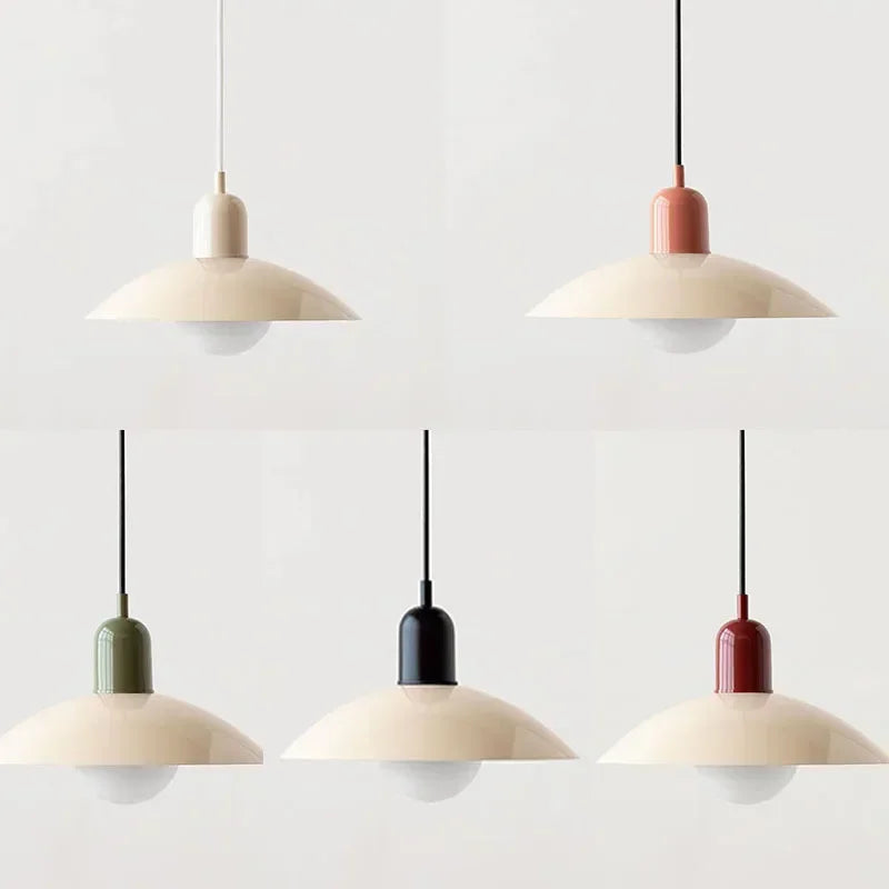 Set of five pendant lights with different colored bases on a light gray background