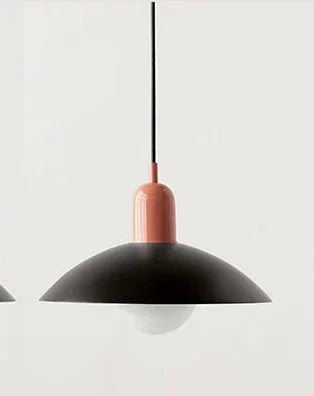 Modern pendant light with black shade and rose gold fixture on a white background