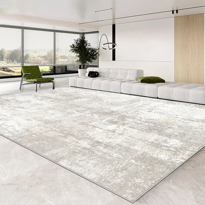 Modern living room with a large area rug, white sofa, and green chair.