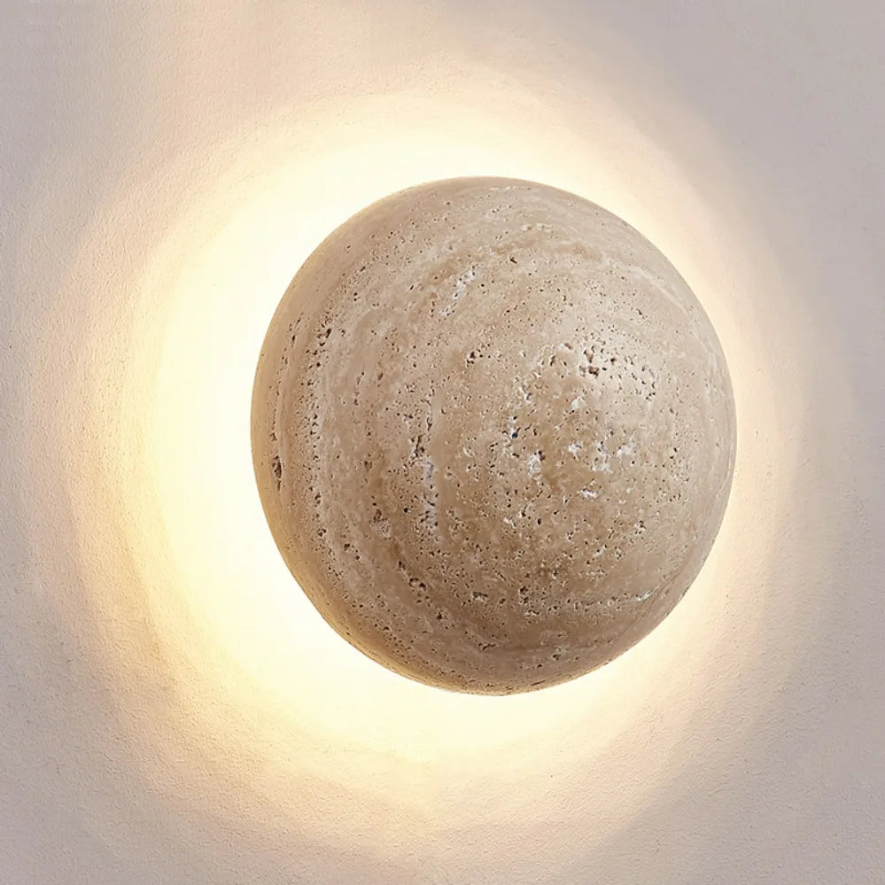 Round concrete wall light fixture on a neutral background