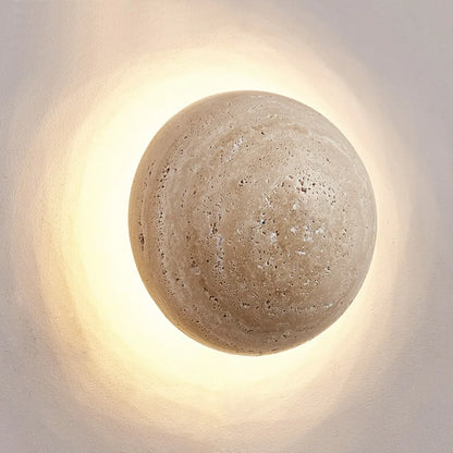Round concrete wall light fixture on a neutral background
