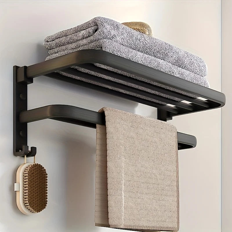 Towel rack with folded towels and a scrubber on a light background