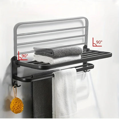 Black towel rack with folded towels on a white background