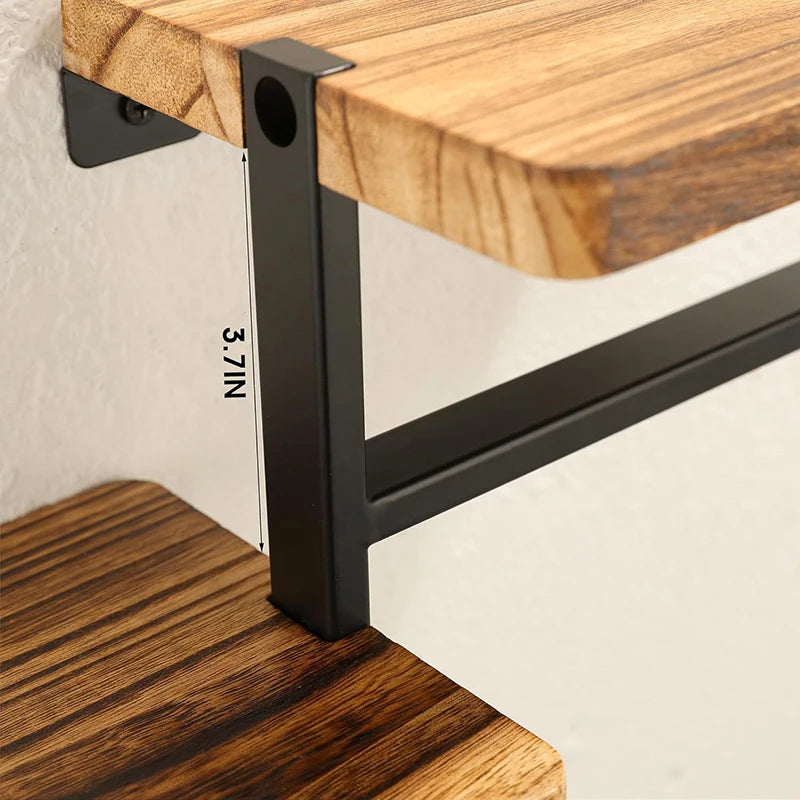 Wooden shelf with black metal bracket and measurement label on a white wall background
