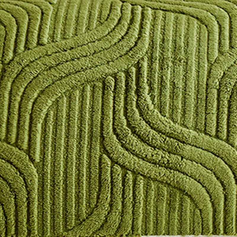 Close-up of a textured green rug with wavy pattern