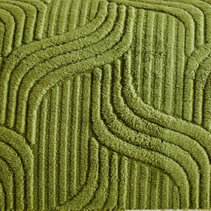 Close-up of a textured green rug with wavy pattern