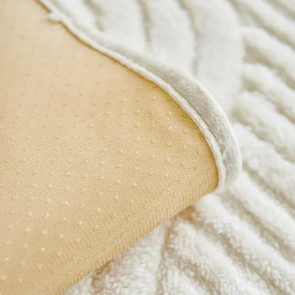 Close-up of beige textured fabric with white fluffy material in the background