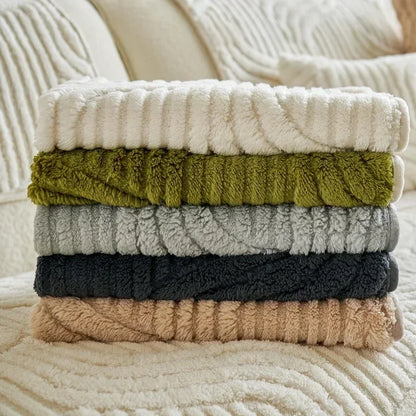 Stack of textured towels in various colors on a soft surface