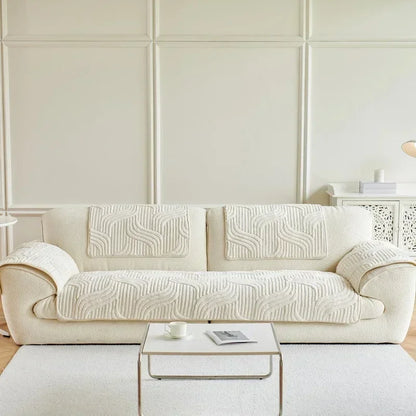White sofa with patterned cushions in a minimalistic living room.