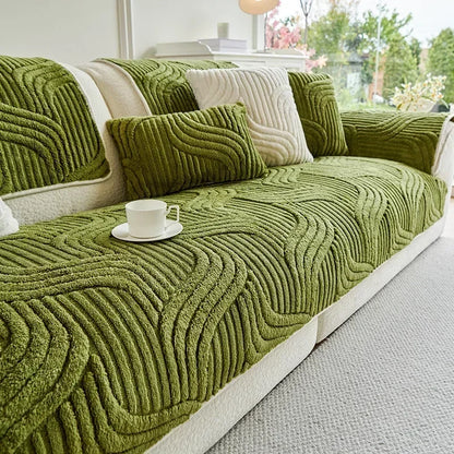 Green textured sofa cover on a sofa with a cup and saucer on a table.